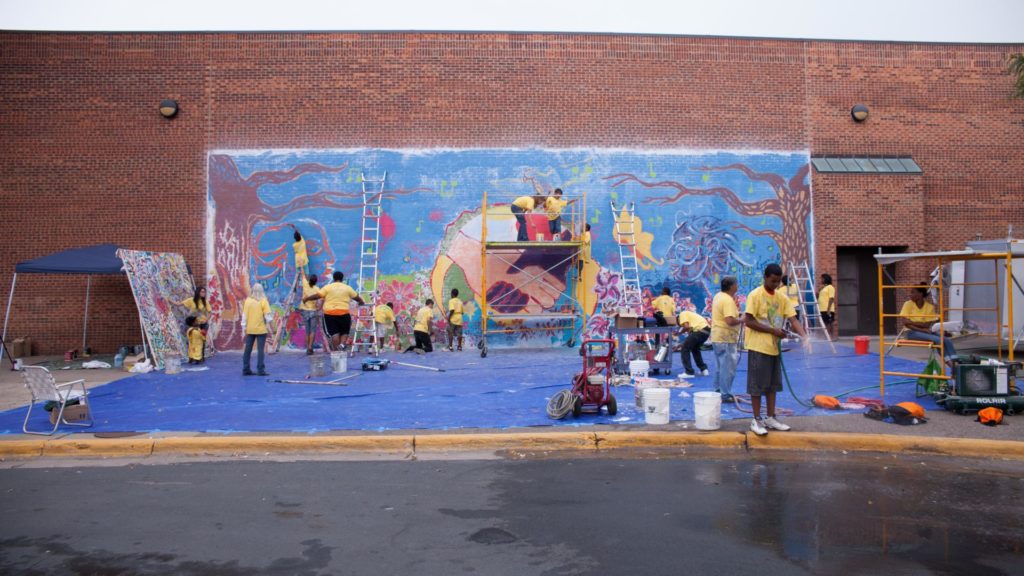 Group of kids working on a mural