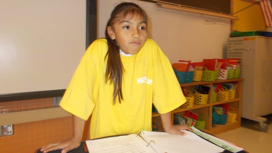 Young girl in yellow shirt being a boss