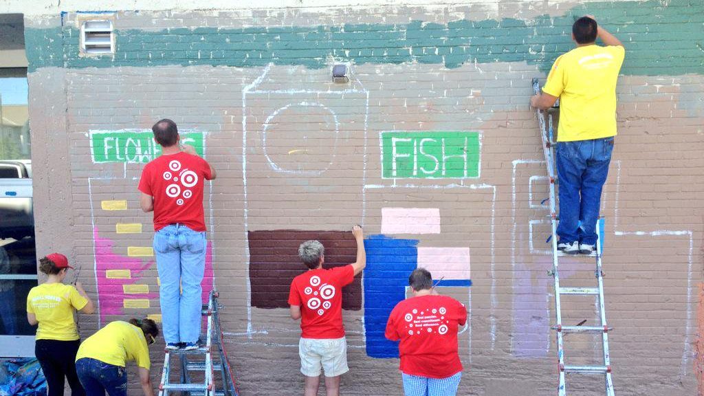 Volunteers working on a mural